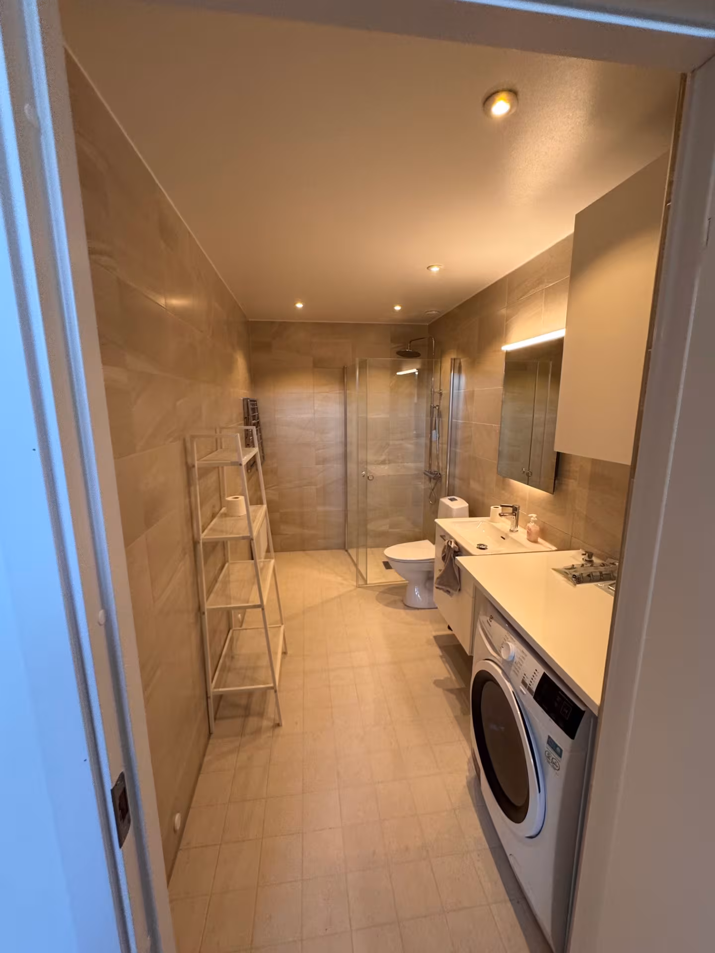 Bathroom with rain shower and laundry