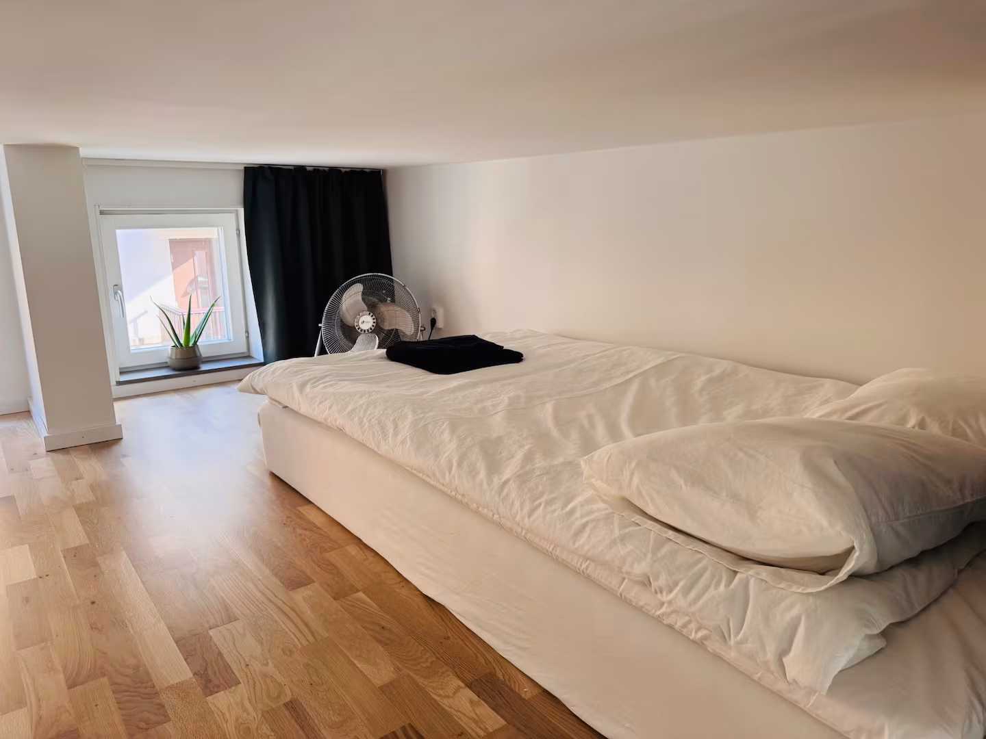 Sleeping loft with wooden floor and window