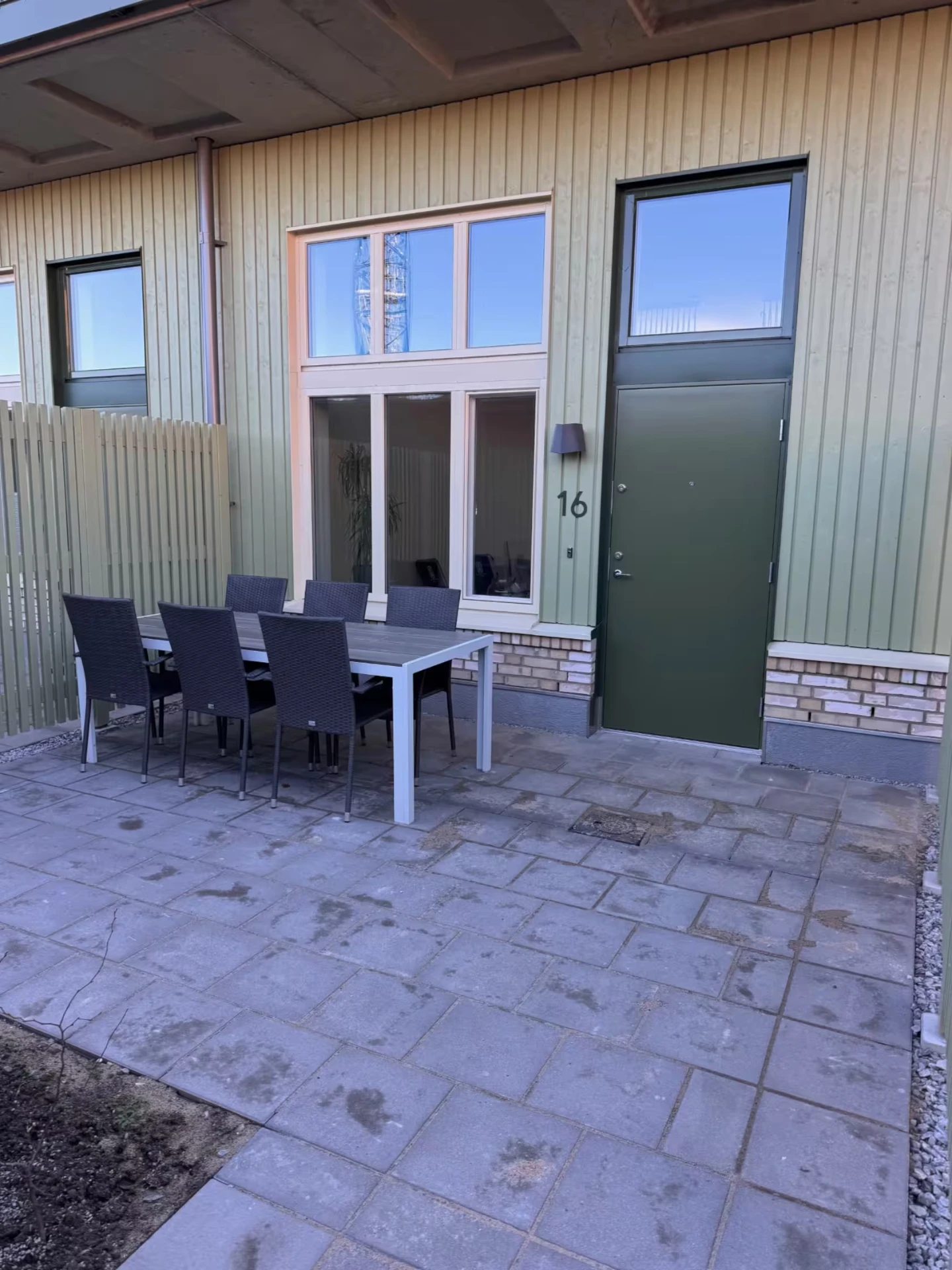 Private paved terrace with outdoor dining set by the entrance